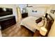 Bedroom features a bed, tile floor, a ceiling fan, and a view into the bathroom at 12702 W Ashwood Dr, Sun City West, AZ 85375