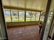 Enclosed patio featuring tile flooring and views of the golf course and landscaping at 12702 W Ashwood Dr, Sun City West, AZ 85375