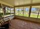 Relaxing enclosed patio with tile flooring featuring golf course views, and a rocking chair at 12702 W Ashwood Dr, Sun City West, AZ 85375