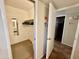 Walk-in closet with rod for hanging clothes, carpet, a mirror, and view to the bathroom at 12702 W Ashwood Dr, Sun City West, AZ 85375