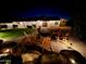 Outdoor patio seating area at night featuring a firepit and stone benches at 1501 N Lesueur --, Mesa, AZ 85203