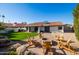 Spacious backyard featuring a cozy seating area around a firepit and manicured lawn at 1501 N Lesueur --, Mesa, AZ 85203