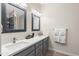 Bathroom featuring double sinks, quartz countertops, and decorative mirrors at 1501 N Lesueur --, Mesa, AZ 85203