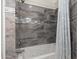 Modern bathroom featuring a soaking tub with sleek grey stone surround and stylish shower curtain at 1501 N Lesueur --, Mesa, AZ 85203
