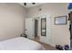 Well-lit bedroom with a door leading to another room, wood floors, and a closet at 1501 N Lesueur --, Mesa, AZ 85203