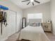 Bright bedroom featuring a queen bed, ceiling fan, and a closet with mirrored doors at 1501 N Lesueur --, Mesa, AZ 85203