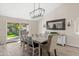 Bright dining area with a modern chandelier and slider access to the backyard at 1501 N Lesueur --, Mesa, AZ 85203