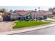 Charming single-story home featuring well-manicured landscaping with lush green lawn and mature trees at 1501 N Lesueur --, Mesa, AZ 85203
