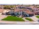 Attractive one-story home boasting a well-maintained front yard with green lawn and desert landscaping at 1501 N Lesueur --, Mesa, AZ 85203