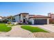 Inviting single-story home featuring manicured landscaping, a red-tile roof, and a covered front entryway at 1501 N Lesueur --, Mesa, AZ 85203