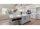 Bright kitchen features white cabinetry, a large island with seating, and stainless steel appliances at 1501 N Lesueur --, Mesa, AZ 85203