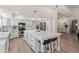 Bright kitchen with large center island, white cabinets, and stainless steel appliances at 1501 N Lesueur --, Mesa, AZ 85203