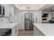 Bright kitchen features stainless steel appliances, white cabinets, and stone countertops at 1501 N Lesueur --, Mesa, AZ 85203