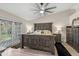 Main bedroom with a wooden bed frame, neutral paint, and access to the backyard at 1501 N Lesueur --, Mesa, AZ 85203