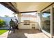 Covered patio featuring a built-in outdoor kitchen and Traeger smoker at 1501 N Lesueur --, Mesa, AZ 85203