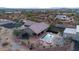 Aerial view of a private backyard featuring a pool, trampoline, and outdoor seating area at 156 E Frontier St, Apache Junction, AZ 85119