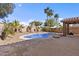 Beautiful backyard with sparkling pool, desert landscaping, and a spacious patio at 15853 S 17Th Dr, Phoenix, AZ 85045