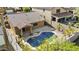 Aerial view of a private backyard pool with a yellow float, surrounded by patio space, landscaping and a tall privacy fence at 15853 S 17Th Dr, Phoenix, AZ 85045