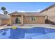 Backyard with sparkling swimming pool, covered patio, and desert landscaping at 15853 S 17Th Dr, Phoenix, AZ 85045