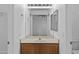 A bright bathroom features a single-sink vanity and a decorative mirror at 15853 S 17Th Dr, Phoenix, AZ 85045