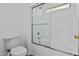 A bathroom features a shower-over-tub with glass doors and a low-flow toilet at 15853 S 17Th Dr, Phoenix, AZ 85045