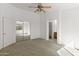 Bright bedroom boasts a ceiling fan and mirrored closet doors to the ensuite bathroom at 15853 S 17Th Dr, Phoenix, AZ 85045