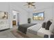Bright bedroom with a ceiling fan, nice carpet, and an ensuite bathroom at 15853 S 17Th Dr, Phoenix, AZ 85045