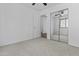 This bedroom includes a mirrored closet, neutral carpet, and a ceiling fan at 15853 S 17Th Dr, Phoenix, AZ 85045