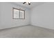 A bedroom with carpet features neutral colored walls, and a window at 15853 S 17Th Dr, Phoenix, AZ 85045