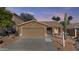 Charming single-story home featuring a two-car garage, desert landscaping, and a covered entryway at 15853 S 17Th Dr, Phoenix, AZ 85045