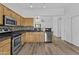 Well-equipped kitchen with stainless steel appliances, granite countertops, and a tiled backsplash at 15853 S 17Th Dr, Phoenix, AZ 85045
