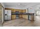 Well-equipped kitchen with stainless steel appliances, granite countertops, and a light wood floor at 15853 S 17Th Dr, Phoenix, AZ 85045