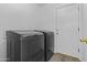 A modern laundry room with side-by-side washer and dryer at 15853 S 17Th Dr, Phoenix, AZ 85045