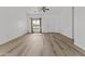 Bright living room featuring light wood flooring, neutral walls, and a large window at 15853 S 17Th Dr, Phoenix, AZ 85045