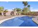 Sparkling pool surrounded by desert landscaping and palm trees, perfect for outdoor relaxation at 15853 S 17Th Dr, Phoenix, AZ 85045