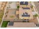 Aerial view of backyard with a patio, fire pit, and solar panels adorning the roofs of the adjacent homes at 17176 W Molly Ln, Surprise, AZ 85387