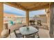Inviting backyard patio with string lights, dining table, and outdoor seating at 17176 W Molly Ln, Surprise, AZ 85387