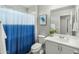 Neat bathroom with a blue-and-white shower curtain, white vanity, and a clean toilet at 17176 W Molly Ln, Surprise, AZ 85387