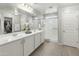 Well-lit bathroom features a double sink vanity and glass-enclosed shower at 17176 W Molly Ln, Surprise, AZ 85387