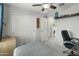 Bright bedroom featuring neutral colors, a ceiling fan and sliding door closet at 17176 W Molly Ln, Surprise, AZ 85387
