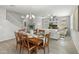 Inviting dining area with a modern chandelier is next to the living room and stairs to the second story at 17176 W Molly Ln, Surprise, AZ 85387