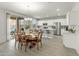 Well-lit dining area flows into the modern kitchen and opens to the outdoor patio through sliding glass doors at 17176 W Molly Ln, Surprise, AZ 85387