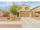 Two-story home features a well-manicured lawn, desert landscaping, and a spacious two-car garage at 17176 W Molly Ln, Surprise, AZ 85387