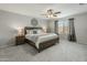 Charming main bedroom with a ceiling fan, king bed, neutral tones, and soft natural light at 17176 W Molly Ln, Surprise, AZ 85387