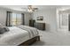 Bright main bedroom with a ceiling fan, king bed, neutral tones, and ample natural light at 17176 W Molly Ln, Surprise, AZ 85387