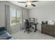 Bright office space with a large window, gray walls, plush carpet, and a ceiling fan at 17176 W Molly Ln, Surprise, AZ 85387