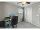 Well-lit office space featuring a window, gray walls, plush carpet, and a ceiling fan at 17176 W Molly Ln, Surprise, AZ 85387