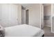 A well lit, mostly white, bedroom with an ensuite bathroom and a walk in closet at 1756 E Bridgeport Pkwy, Gilbert, AZ 85295