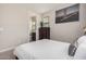 A well lit bedroom that includes an ensuite bathroom, a window, and a modern color palette at 1756 E Bridgeport Pkwy, Gilbert, AZ 85295