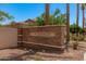 Stone entrance sign for Annecy community surrounded by palm trees and manicured landscaping at 1756 E Bridgeport Pkwy, Gilbert, AZ 85295